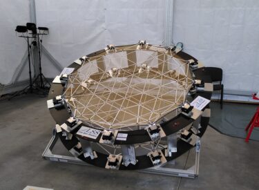 Large Space Reflector demonstrator with a segmented reflective surface supported by a geometric frame and multiple adjustment mechanisms around the perimeter.